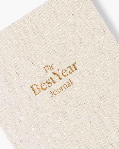 Beige journal with 'The Best Year Journal' embossed in gold on a white background
