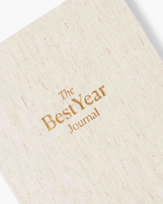 Beige journal with 'The Best Year Journal' embossed in gold on a white background