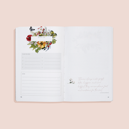 Open notebook with floral design on a beige background