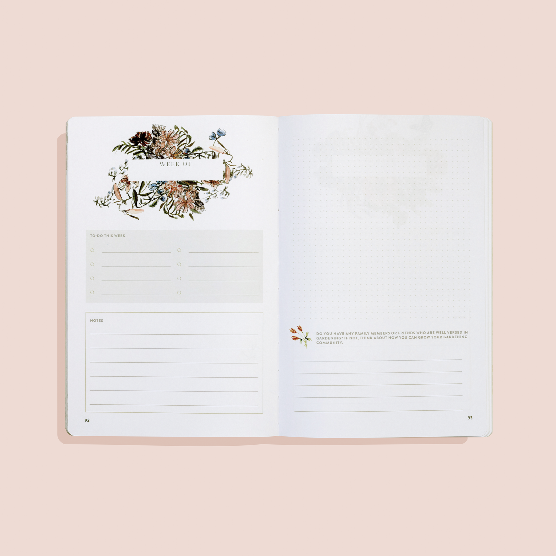 Open planner with floral design on a beige background