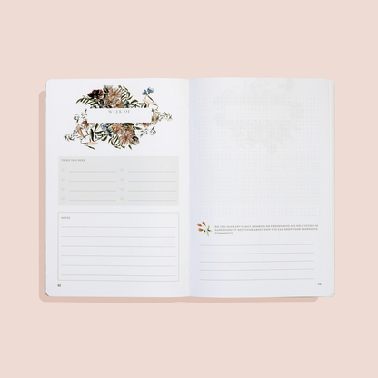 Open planner with floral design on a beige background
