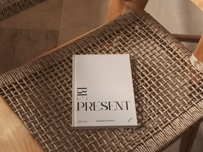 Book titled 'Be Present' on a textured surface