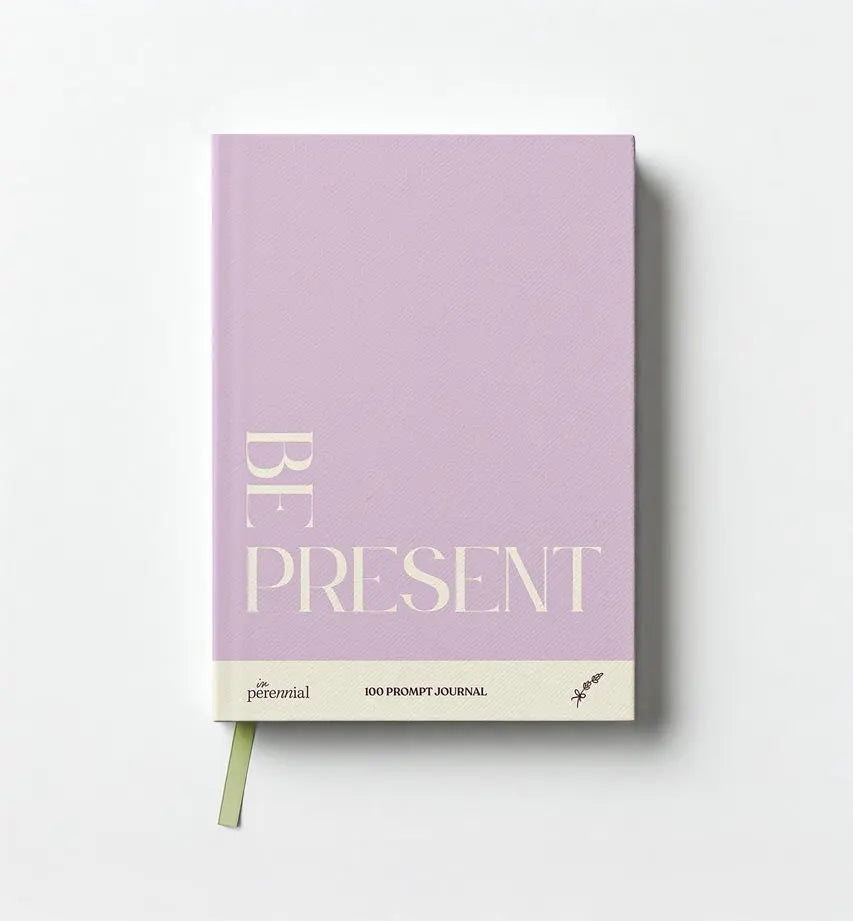 Purple journal with 'Be Present' text on a white background