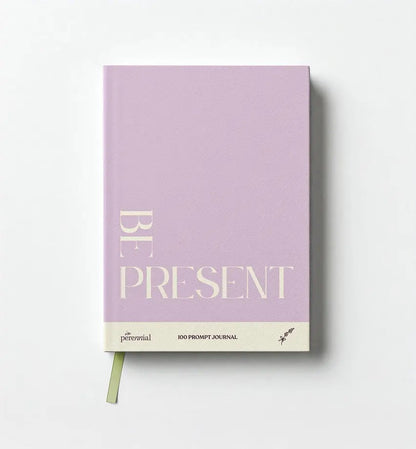 Purple journal with 'Be Present' text on a white background