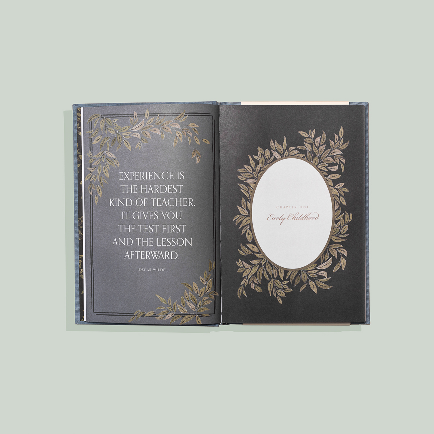 Decorative book with engraved text and design on a light gray background