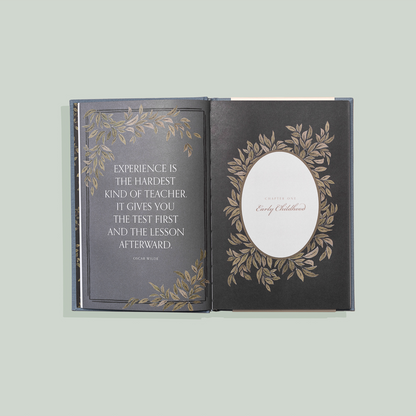 Decorative book with engraved text and design on a light gray background