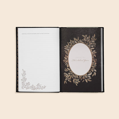 Open book with decorative cover and page on a beige background