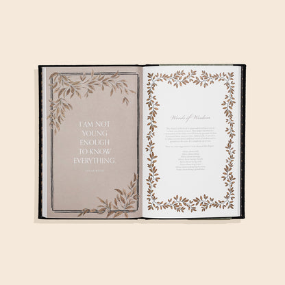 Open book with decorative pages on a beige background