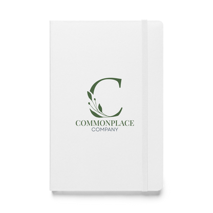 White notebook with The Commonplace Company logo and text on a white background