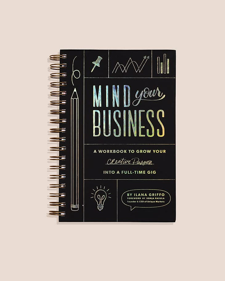 Notebook titled 'Mind Over Business' on a beige background