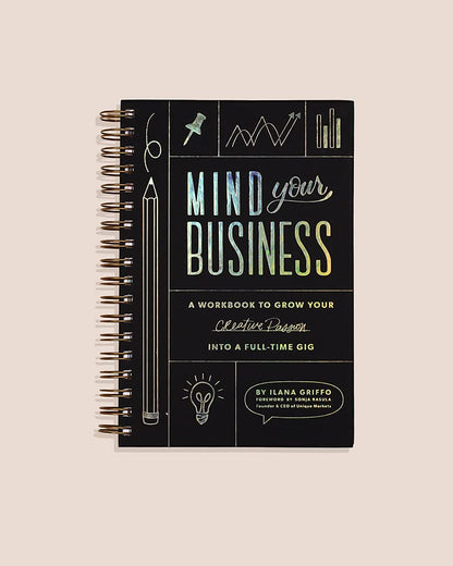 Notebook titled 'Mind Over Business' on a beige background