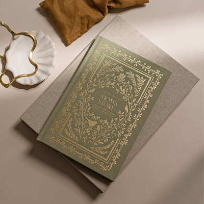 Decorative book with ornate cover on a beige surface