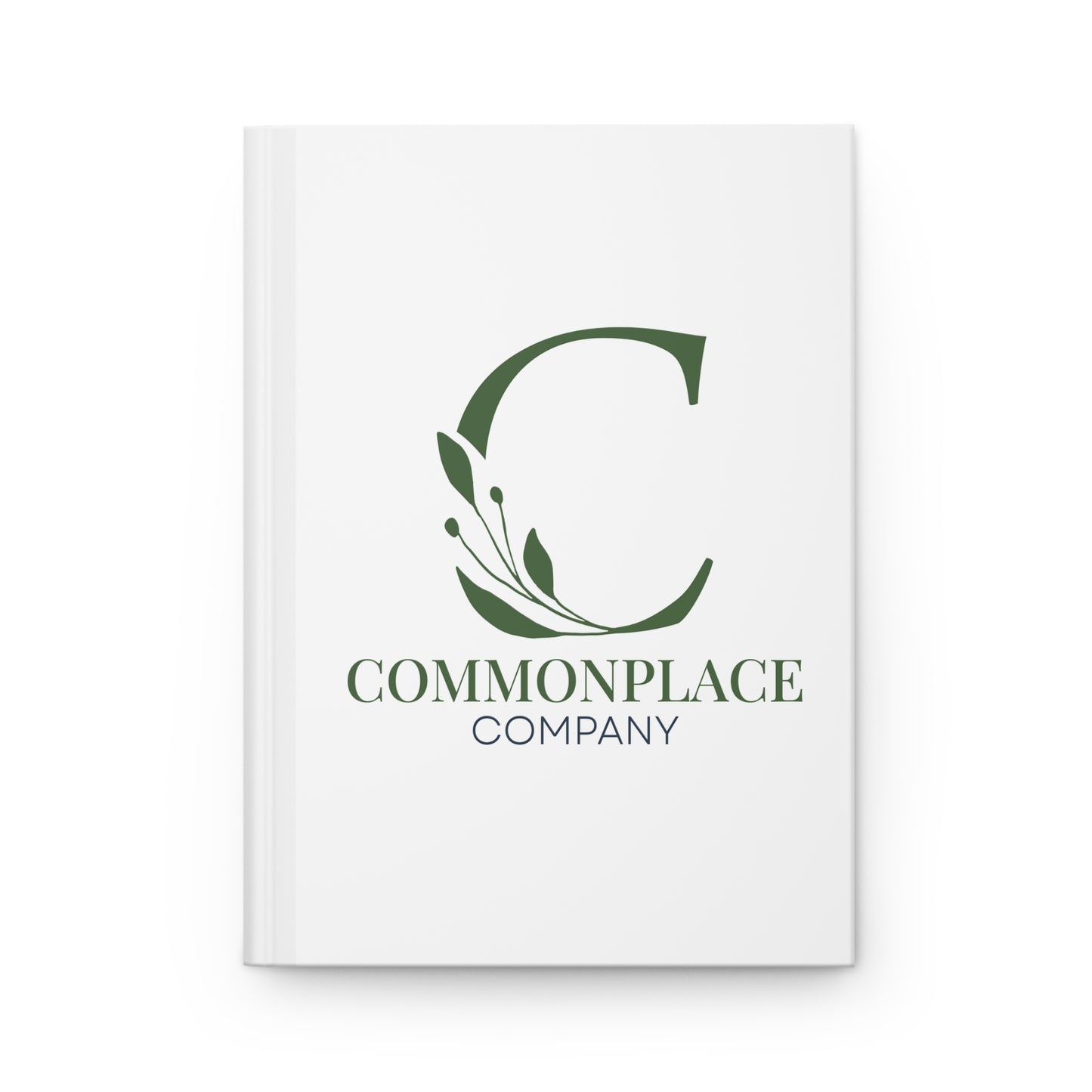 White notebook with The Commonplace Company logo and text on a white background
