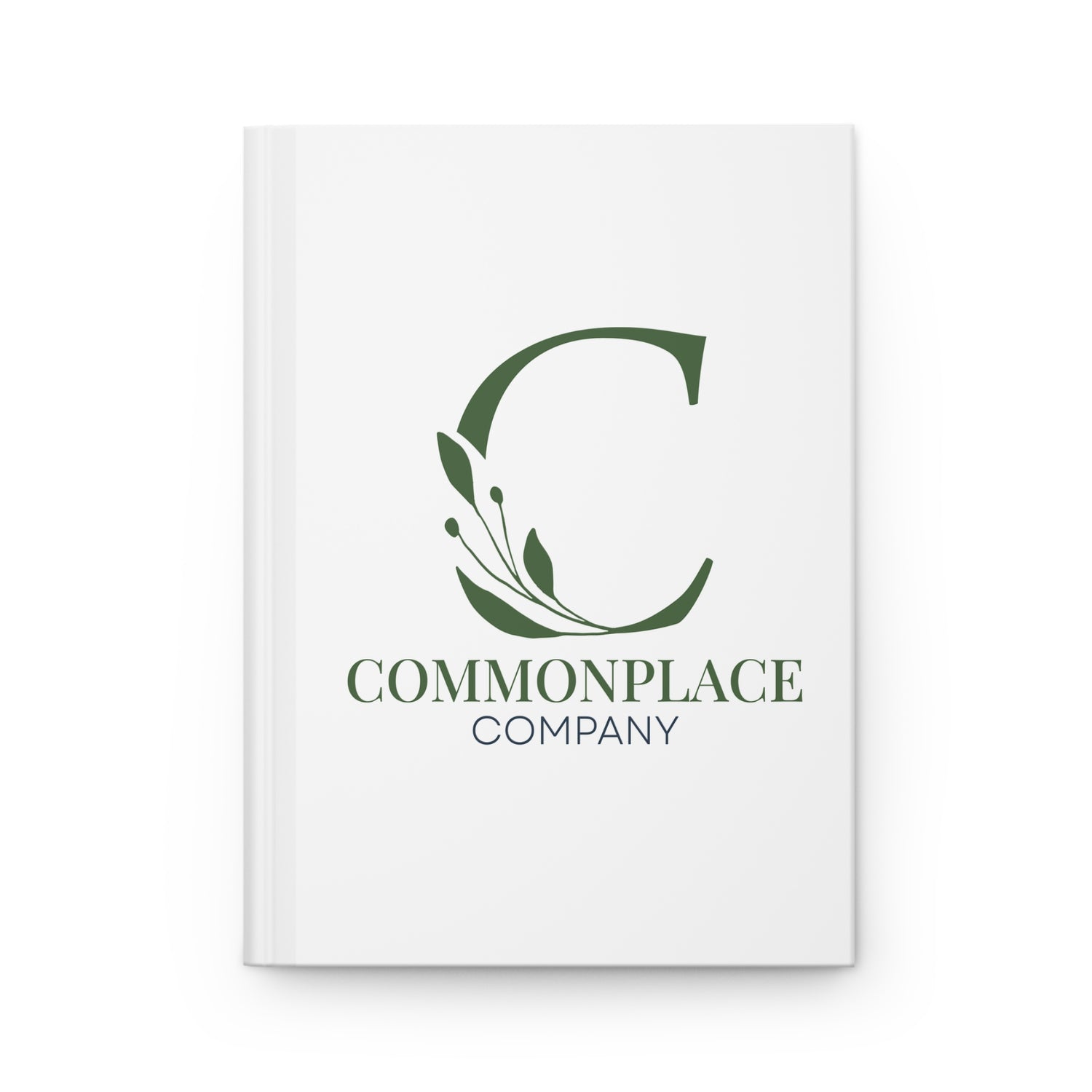 White notebook with The Commonplace Company logo and text on a white background