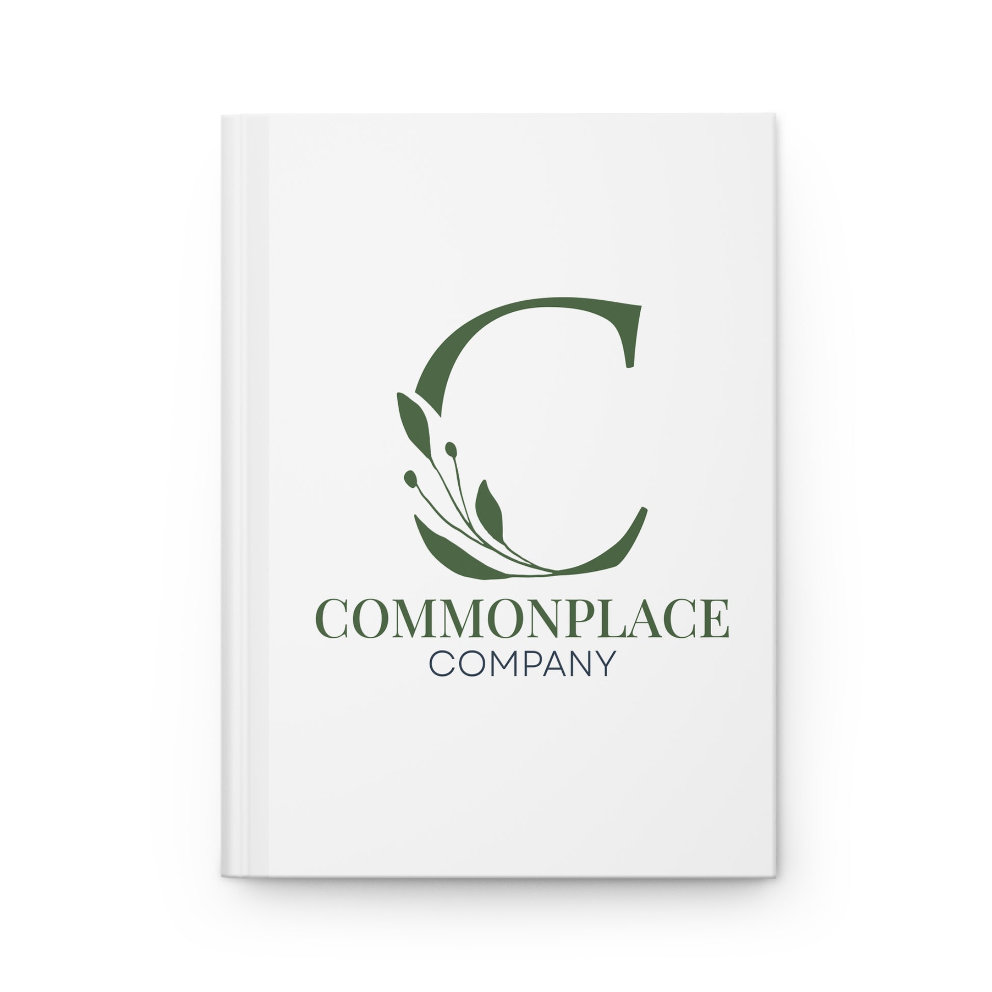 White notebook with The Commonplace Company logo and text on a white background