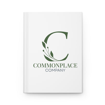 White notebook with The Commonplace Company logo and text on a white background