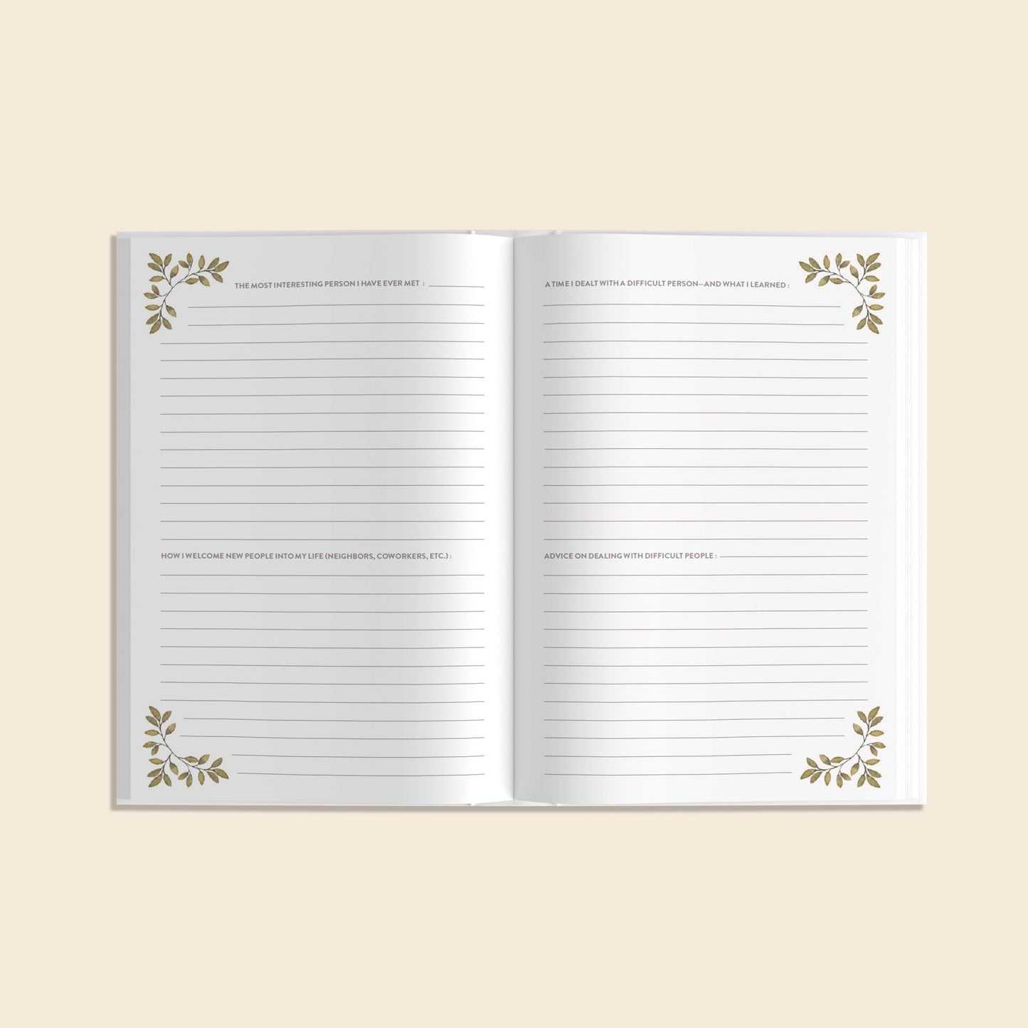 Open notebook with decorative leaves on a beige background