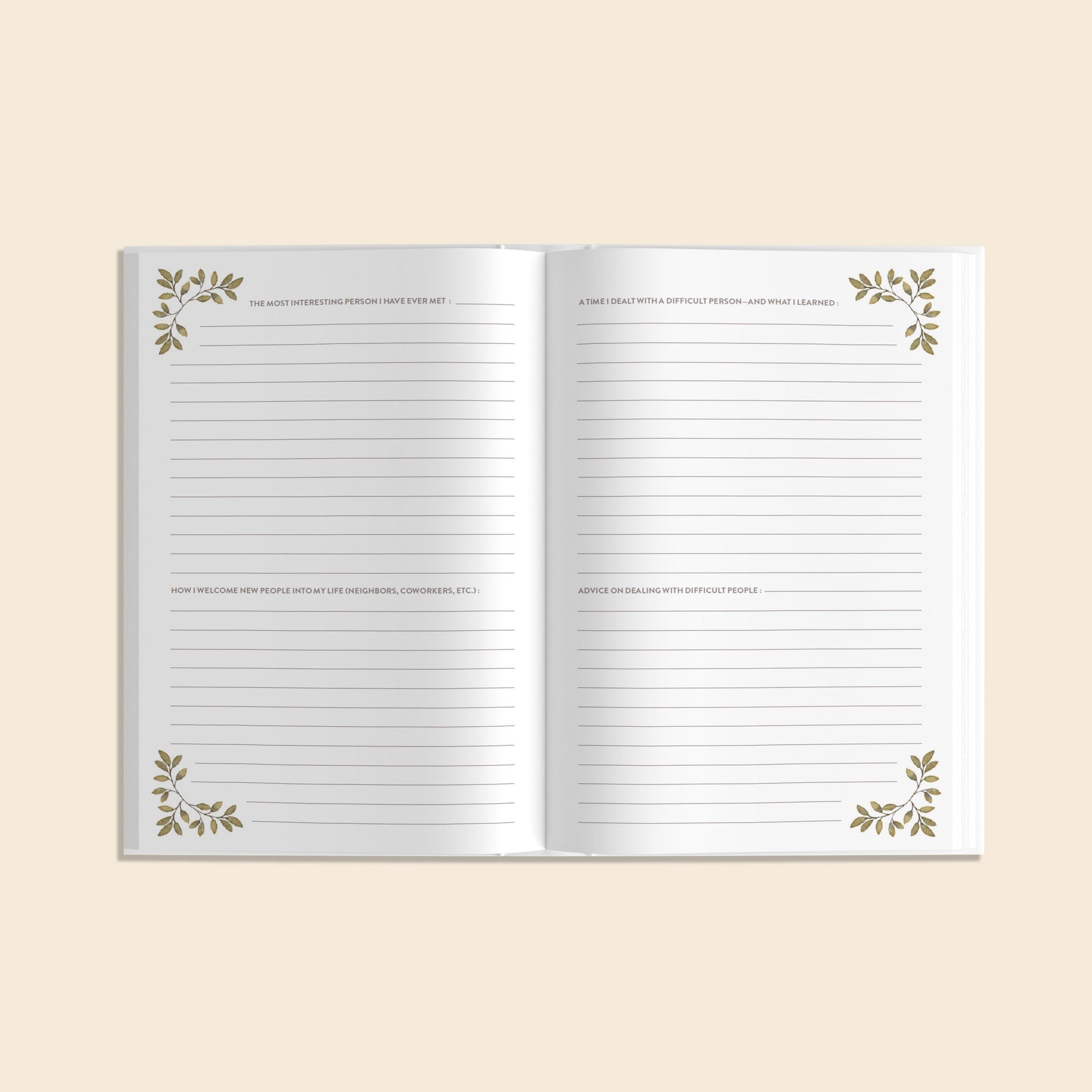 Open notebook with decorative leaves on a beige background