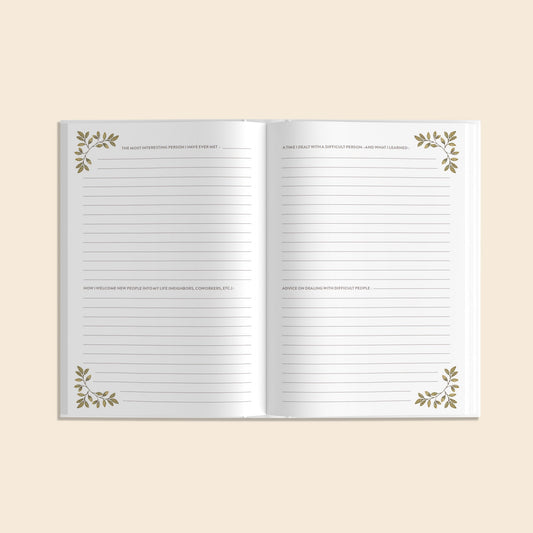 Open notebook with decorative leaves on a beige background