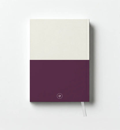 Notebook with a two-tone design, white on top and purple on bottom, on a light gray background.